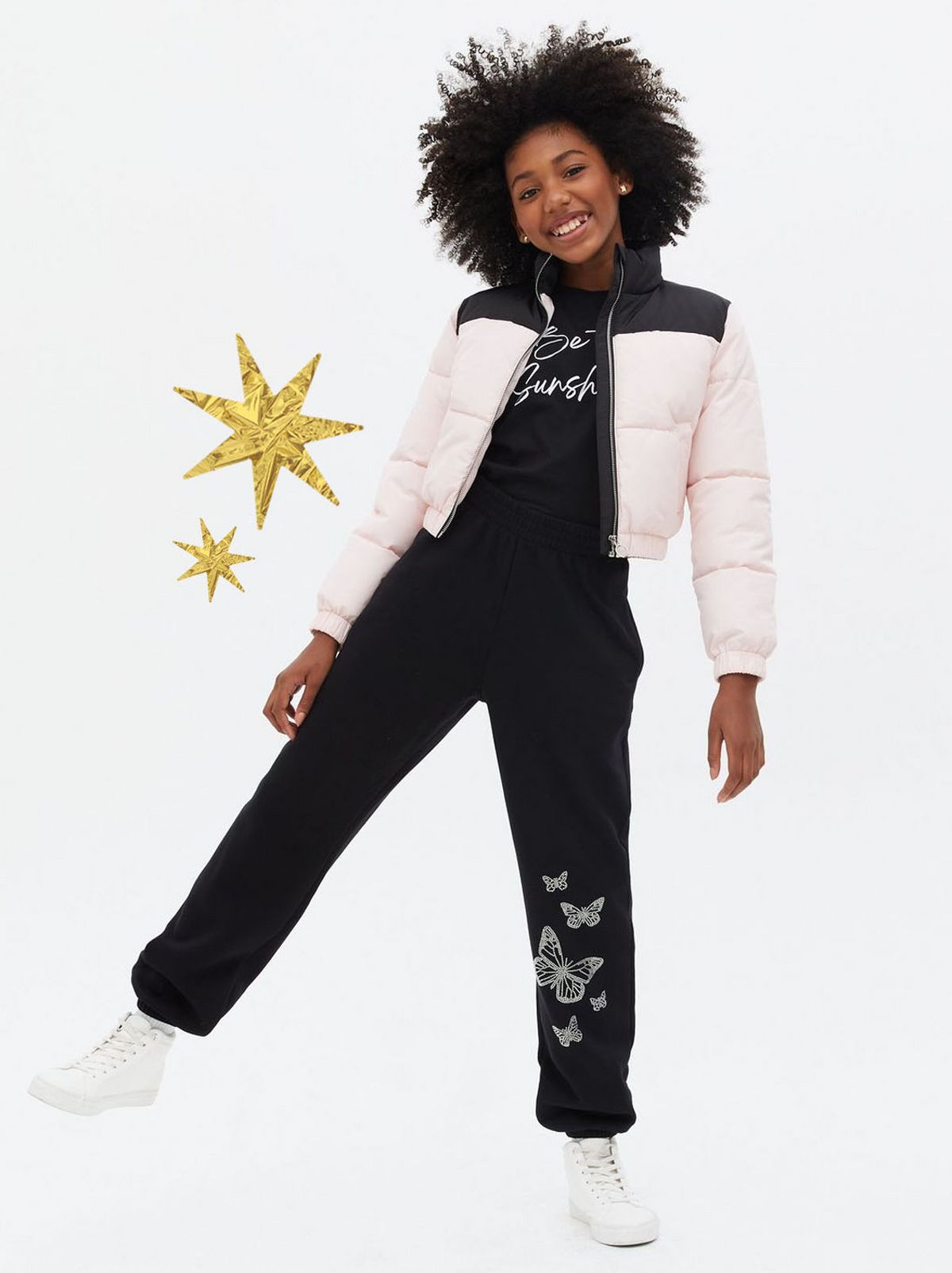 Girl wearing black diamante butterfly joggers 