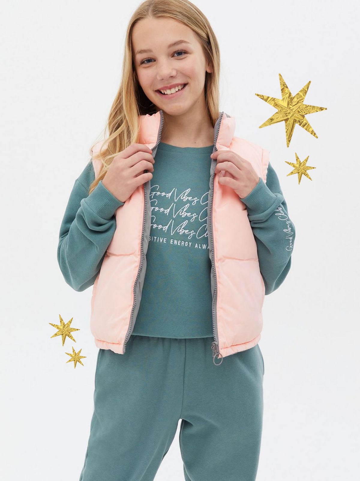 Girl wearing a pale pink high neck gilet