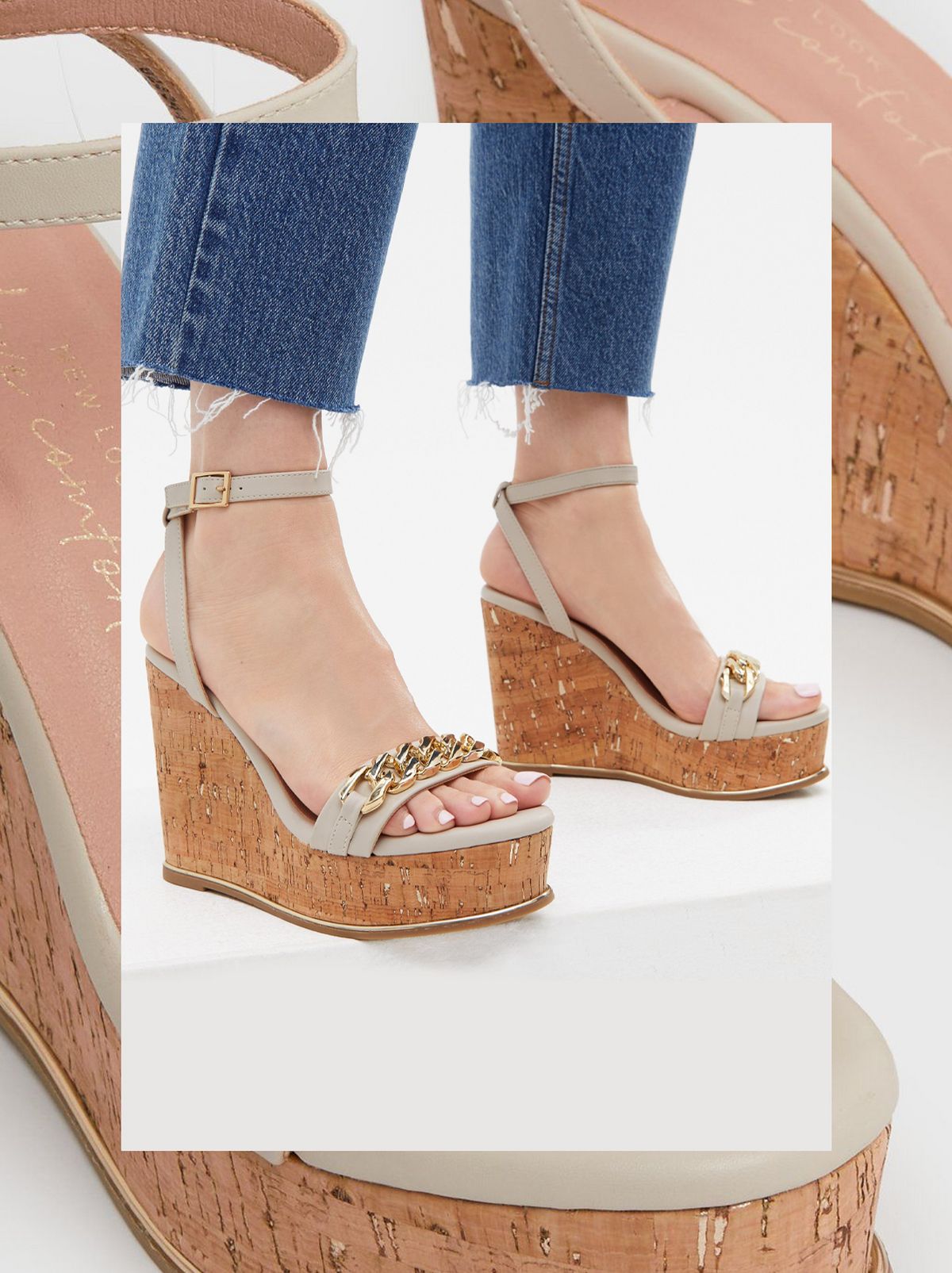 We see a person wearing a pair of off white strappy wedge heel sandals and a pair of straight leg jeans 