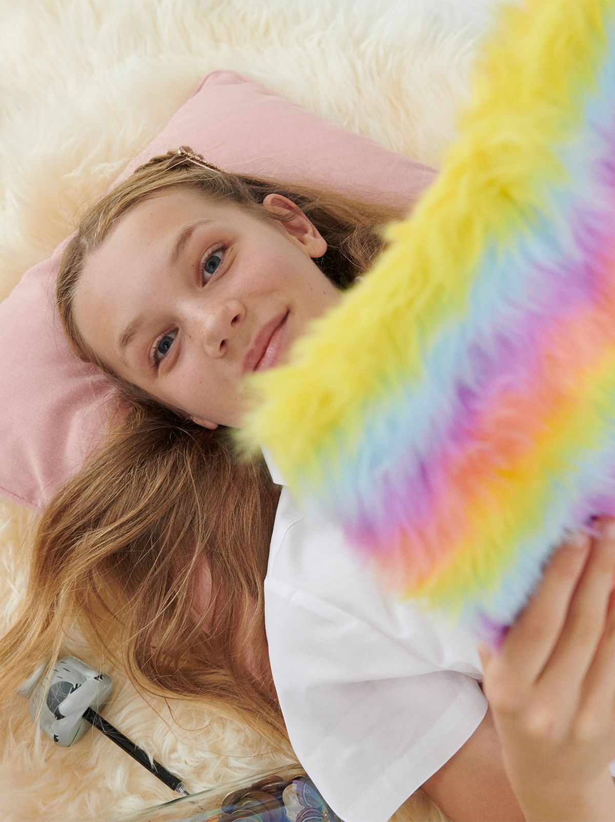 Girl reading through her colourful fluffy notebook.