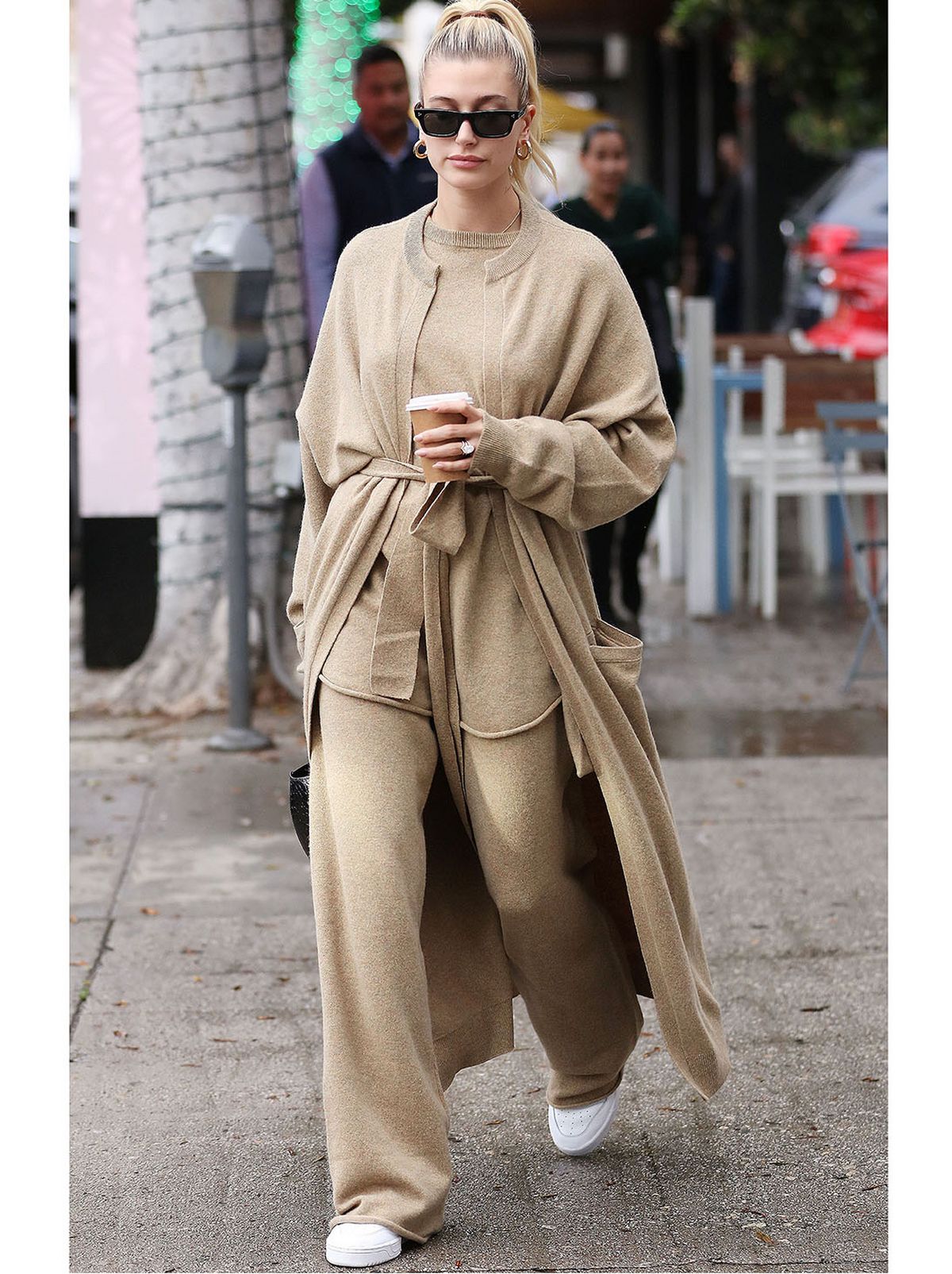 hailey bieber wears matching set of long cardigan, jumper and trousers