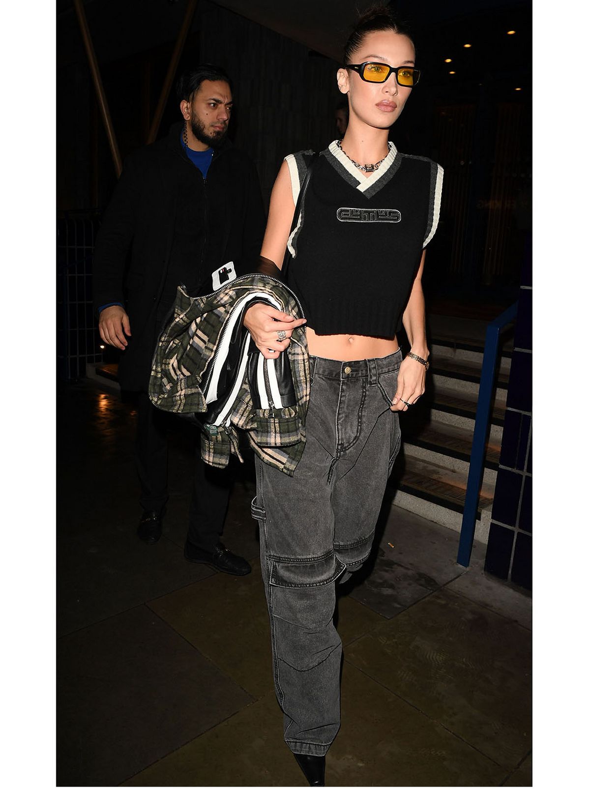 bella hadid wears grey wide leg jeans and black crop top
