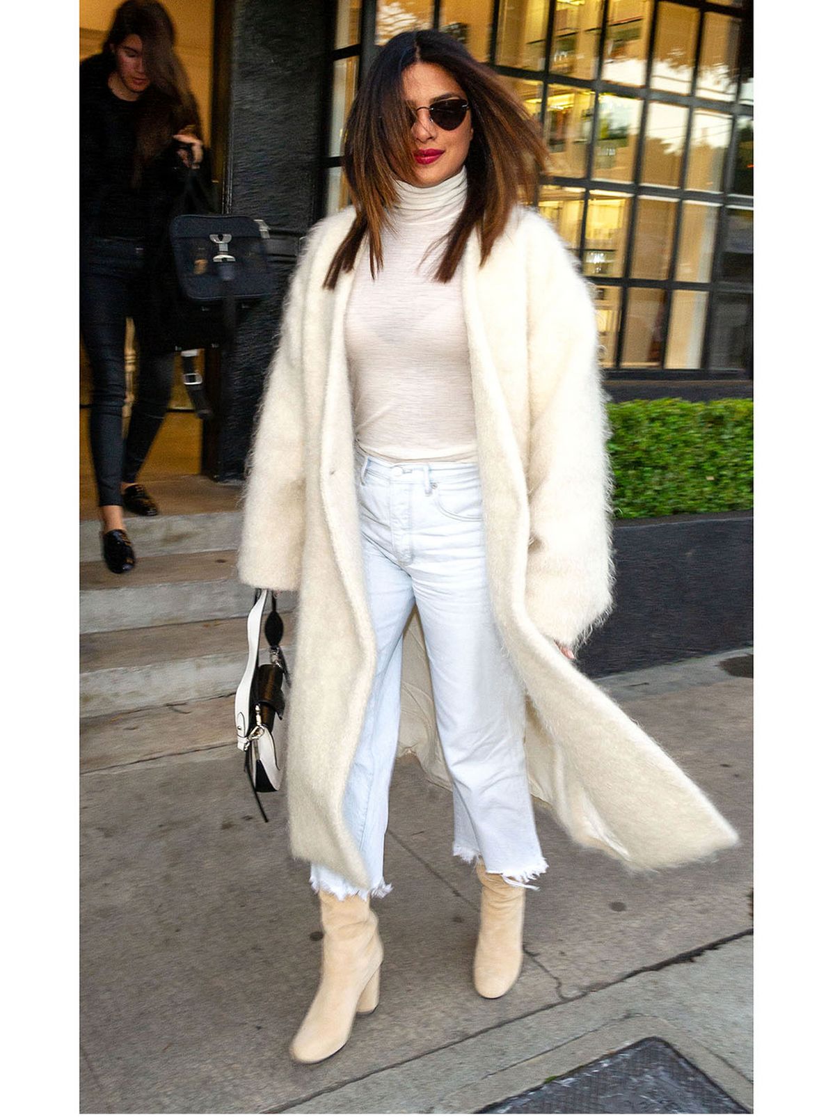 priyanka chopra wears white wide leg jeans, cream high neck top and cream fluffy coat