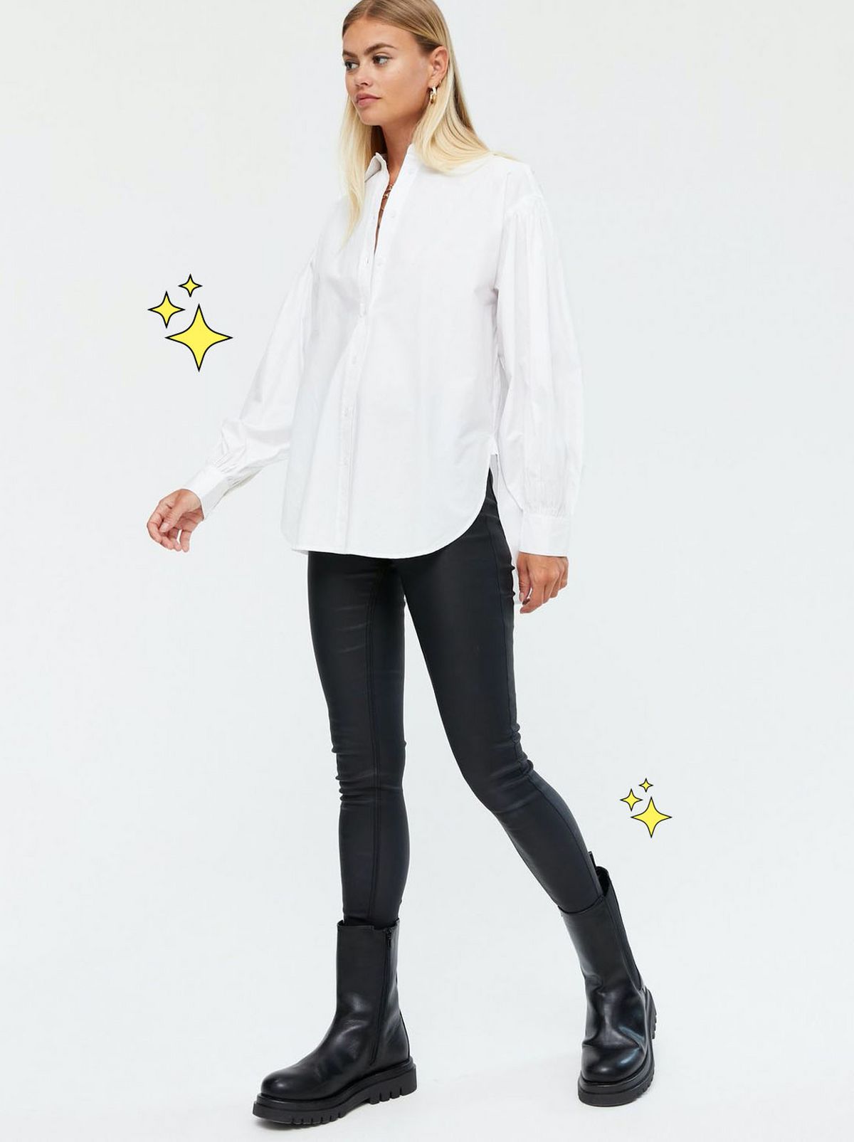Woman wearing a white poplin puff sleeve shirt, black skinny jeans and black boots