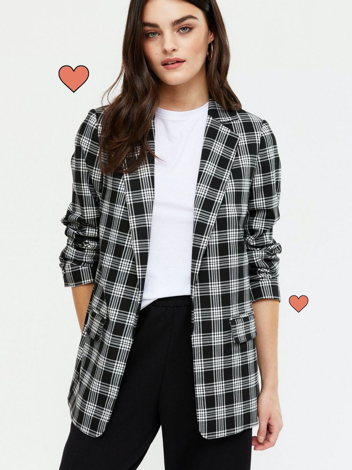 Woman wearing a black check oversized blazer, white top and black trousers