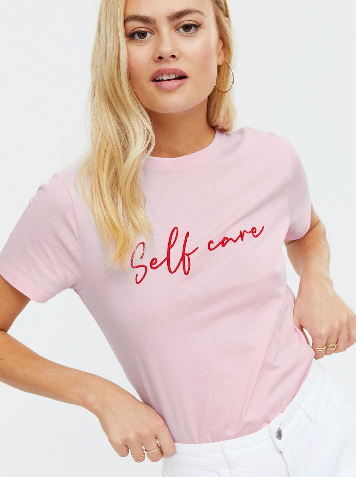 Woman wearing a pink slogan t-shirt