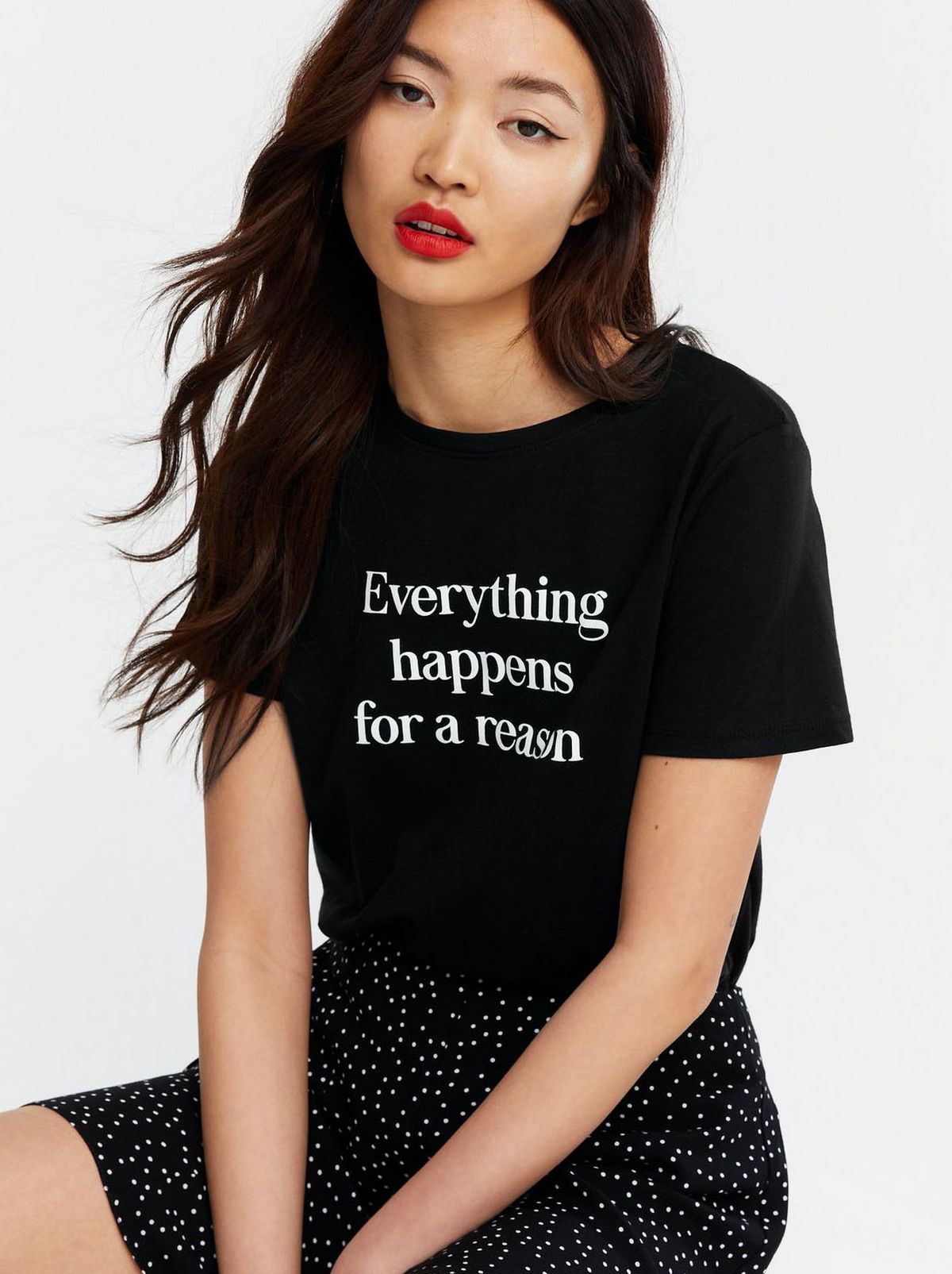 Woman wearing a black slogan t-shirt