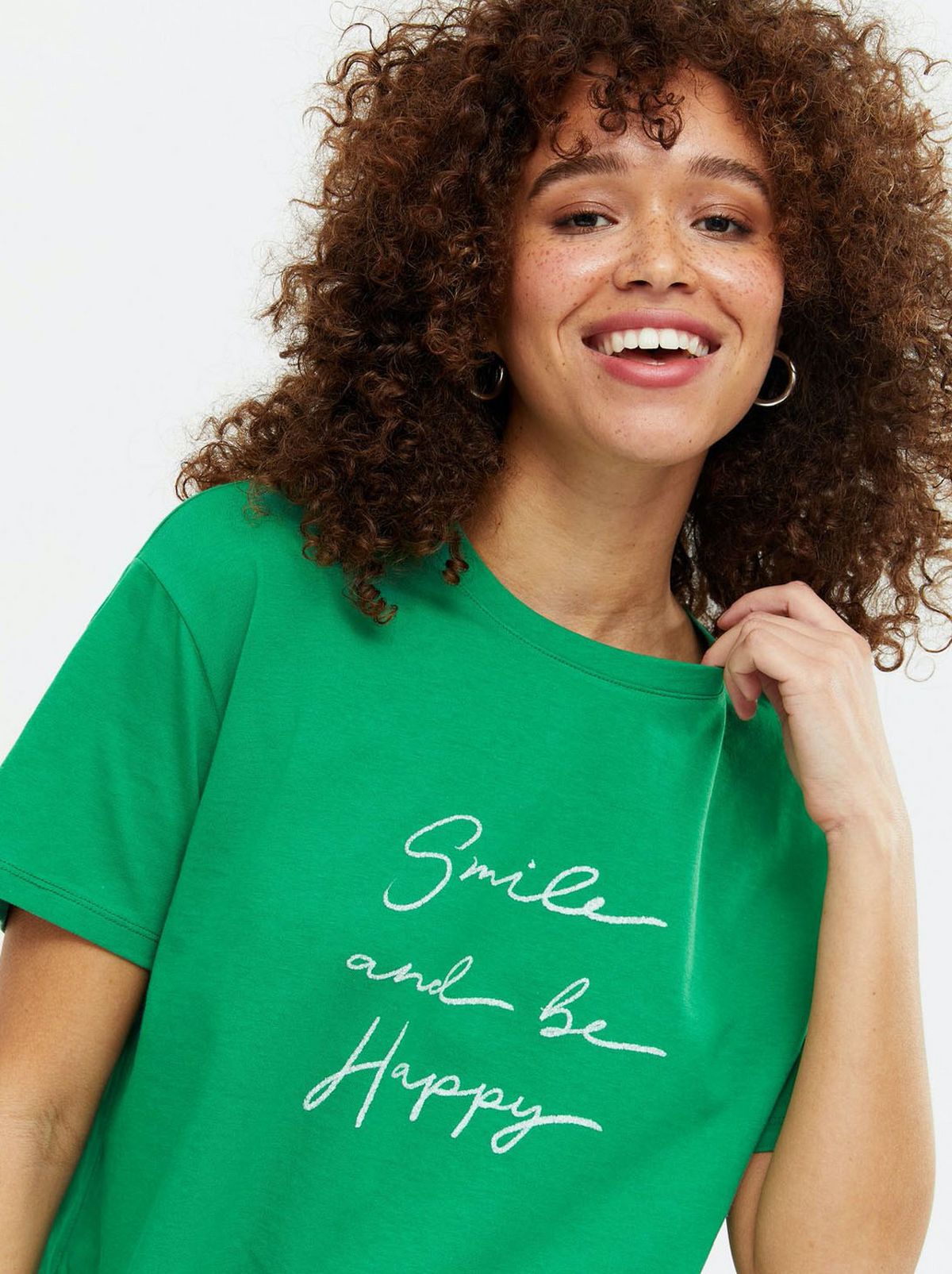 Woman wearing a green slogan t-shirt