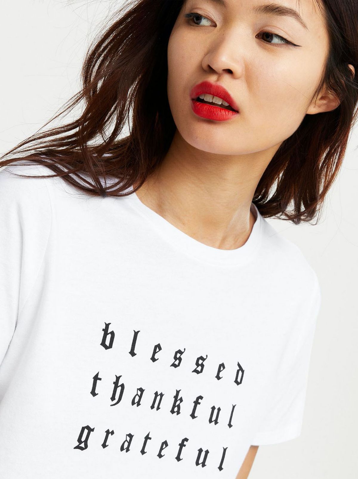 Woman wearing a white slogan t-shirt