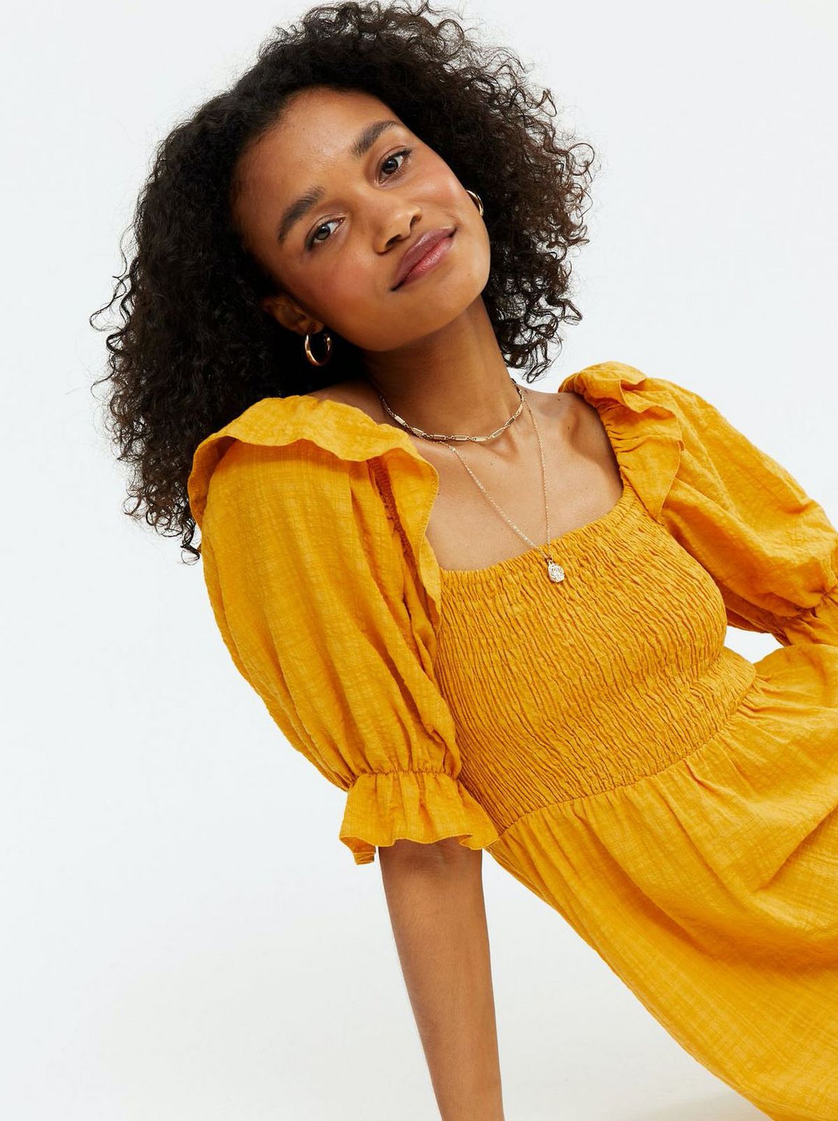 Woman wearing a yellow square neck midi dress