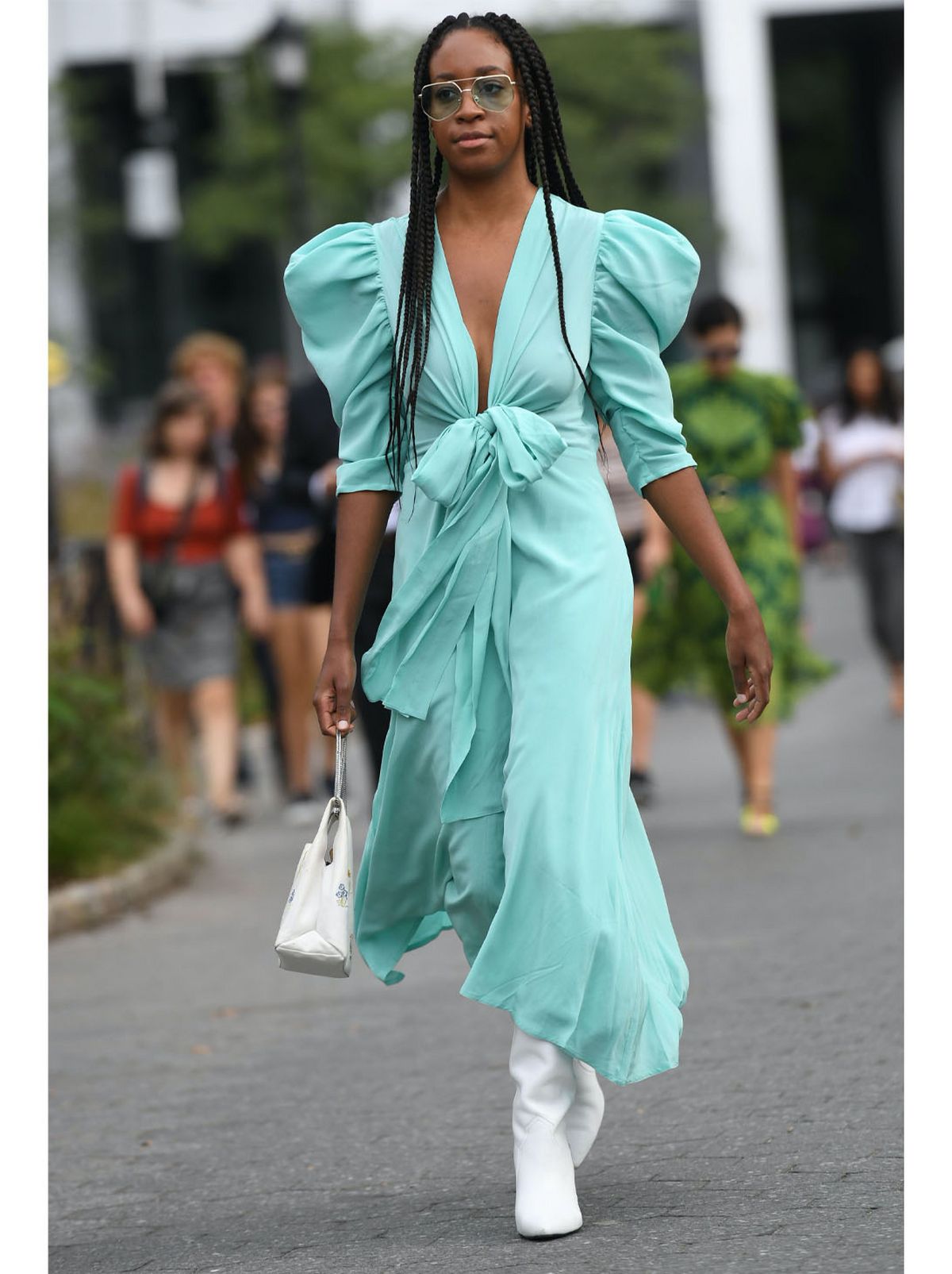 Chrissy Rutherford wearing a light blue midi dress and white boots