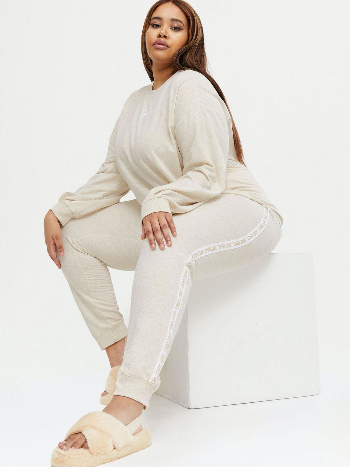 Woman wearing cream loungewear joggers and long sleeve top