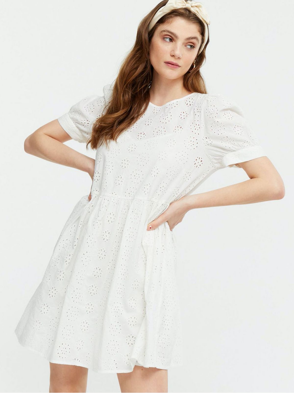 Woman wearing a white puff sleeve mini dress