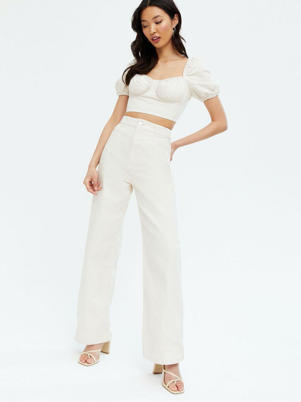 Woman wearing stone wide leg jeans and top