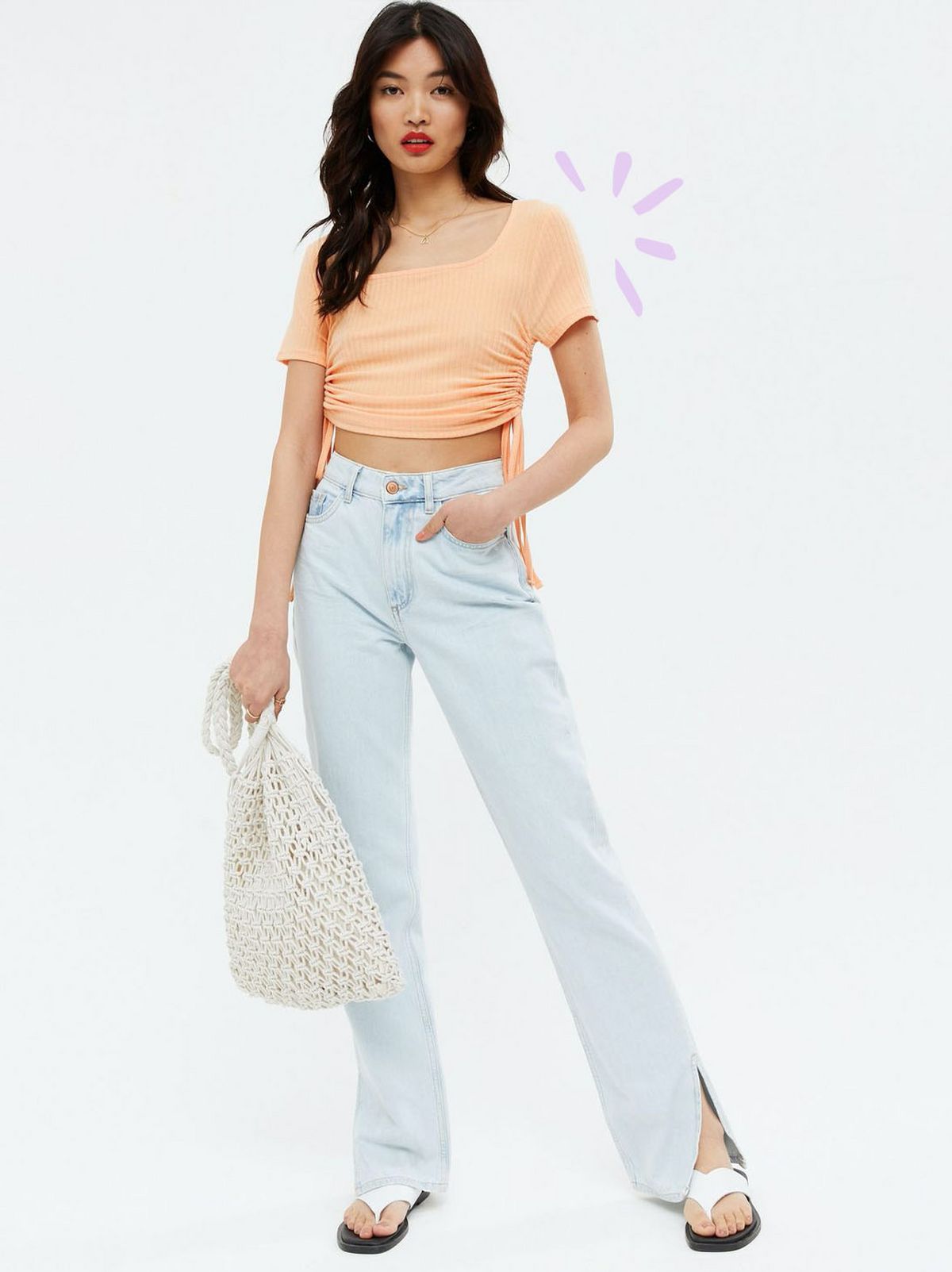 Woman wearing a coral square neck crop t-shirt, blue jeans and flip flops