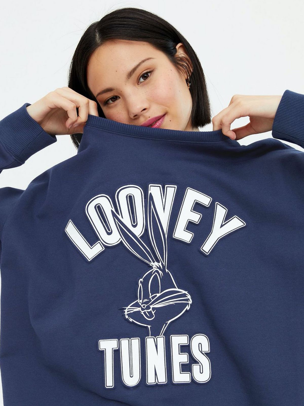 Woman Wearing A Navy Looney Tunes Logo Sweatshirt