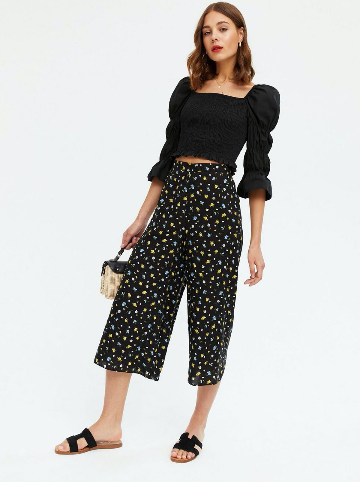 Woman wearing Black Ditsy Floral Wide Leg Crop Trousers, Black Puff Sleeve Top and Sandals