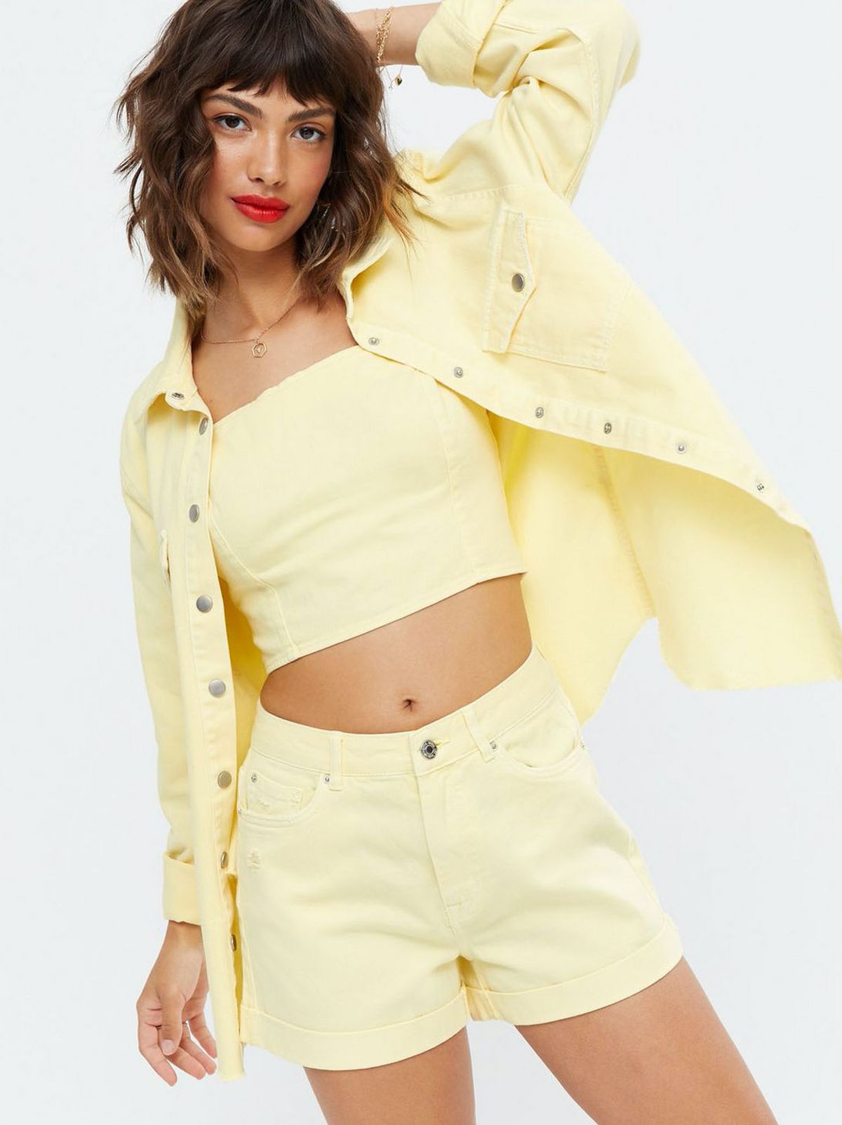 Woman wearing a Yellow Denim Oversized Shirt, yellow crop top and yellow shorts