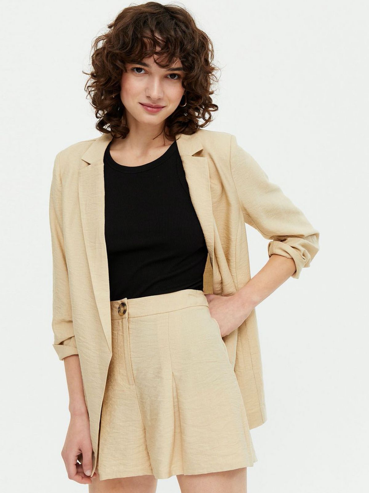 Woman wearing a Stone Roll Sleeve Lightweight Blazer, matching shorts and black top