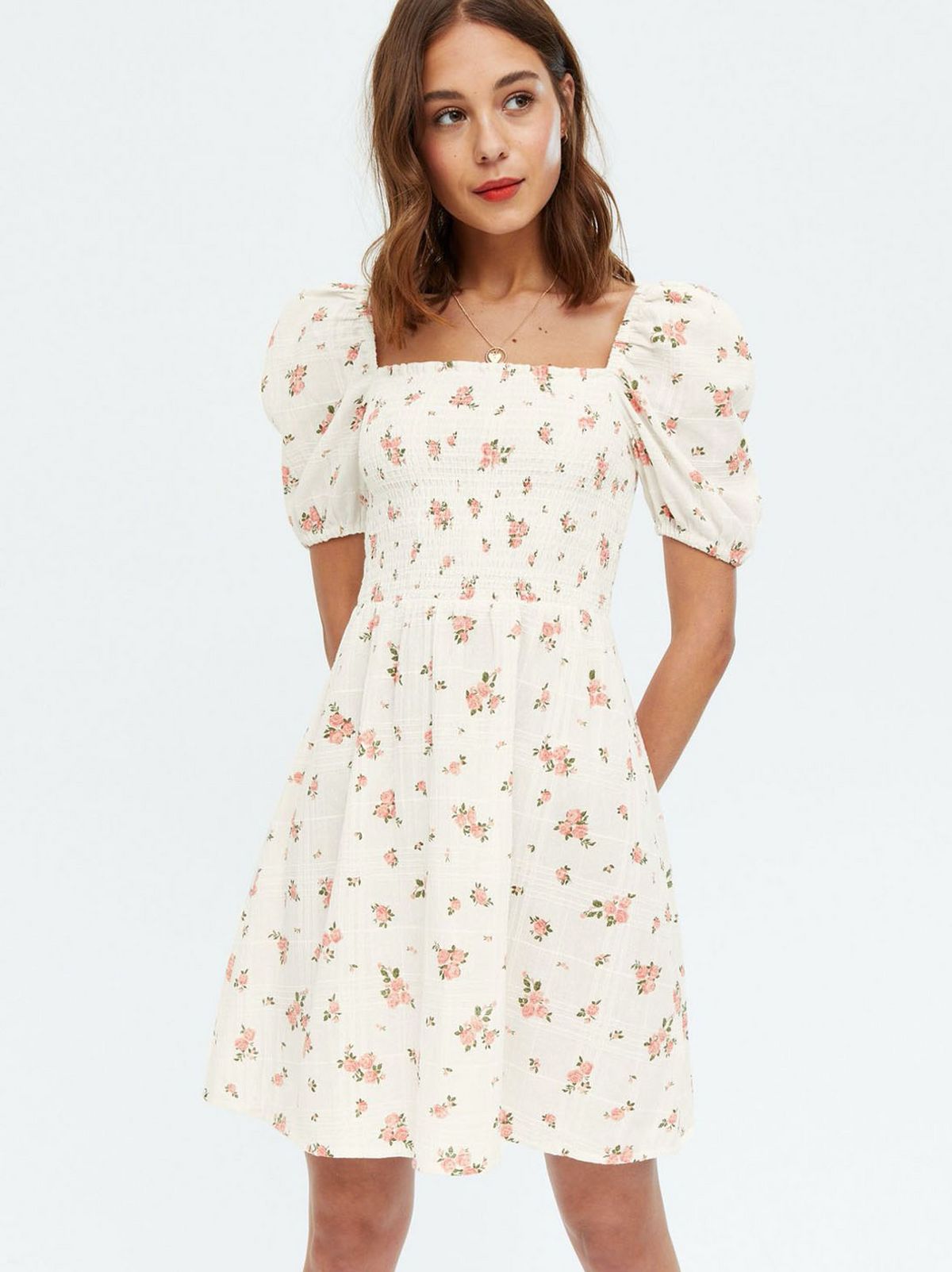 Woman wearing a White Floral Shirred Puff Sleeve Mini Dress