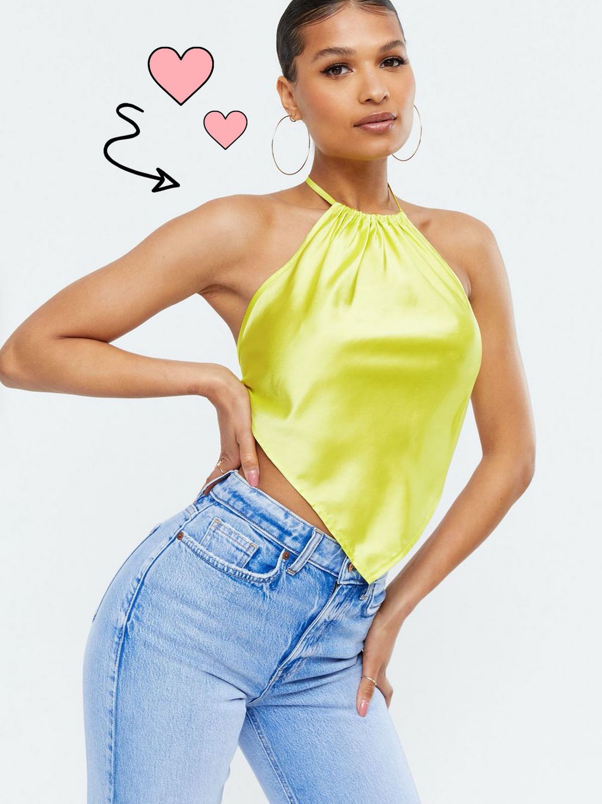 Woman wearing a light green sating later top and blue jeans