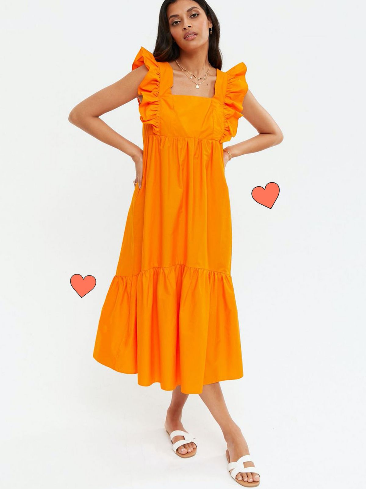 Woman wearing a orange smock midi dress and sliders