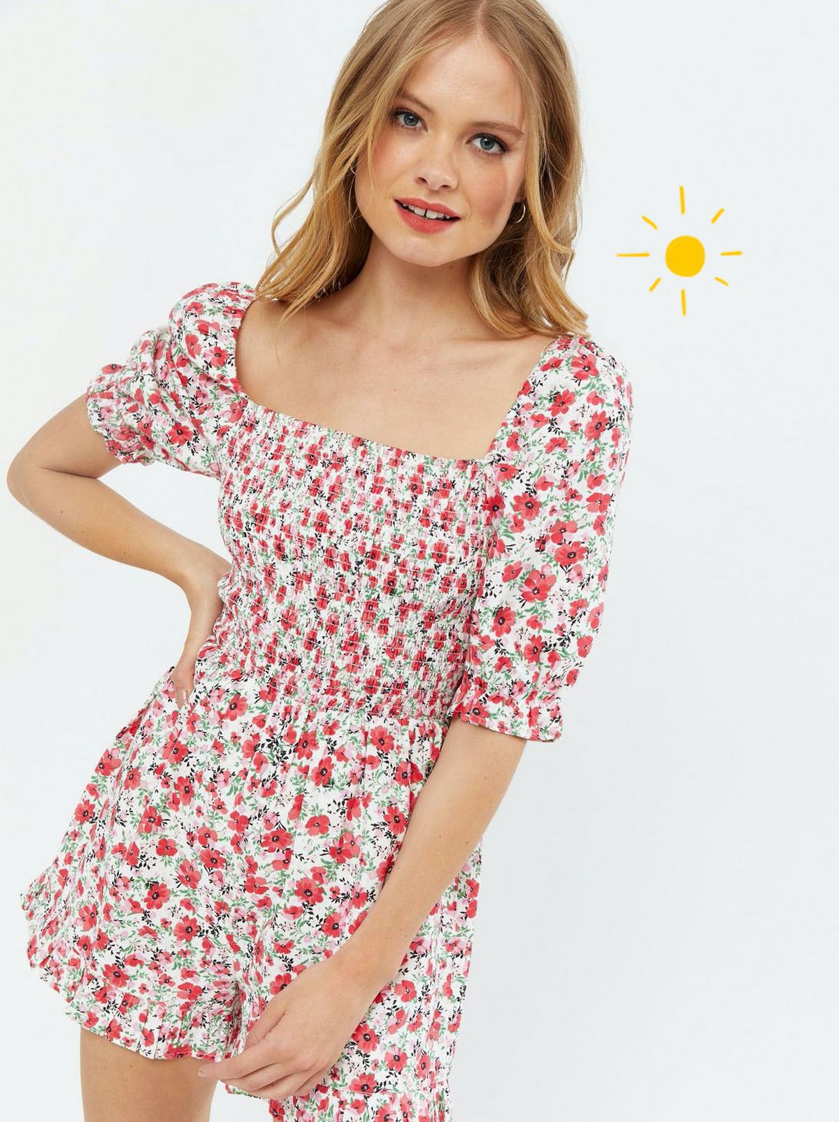 Woman wearing a white floral shirred frill square neck playsuit