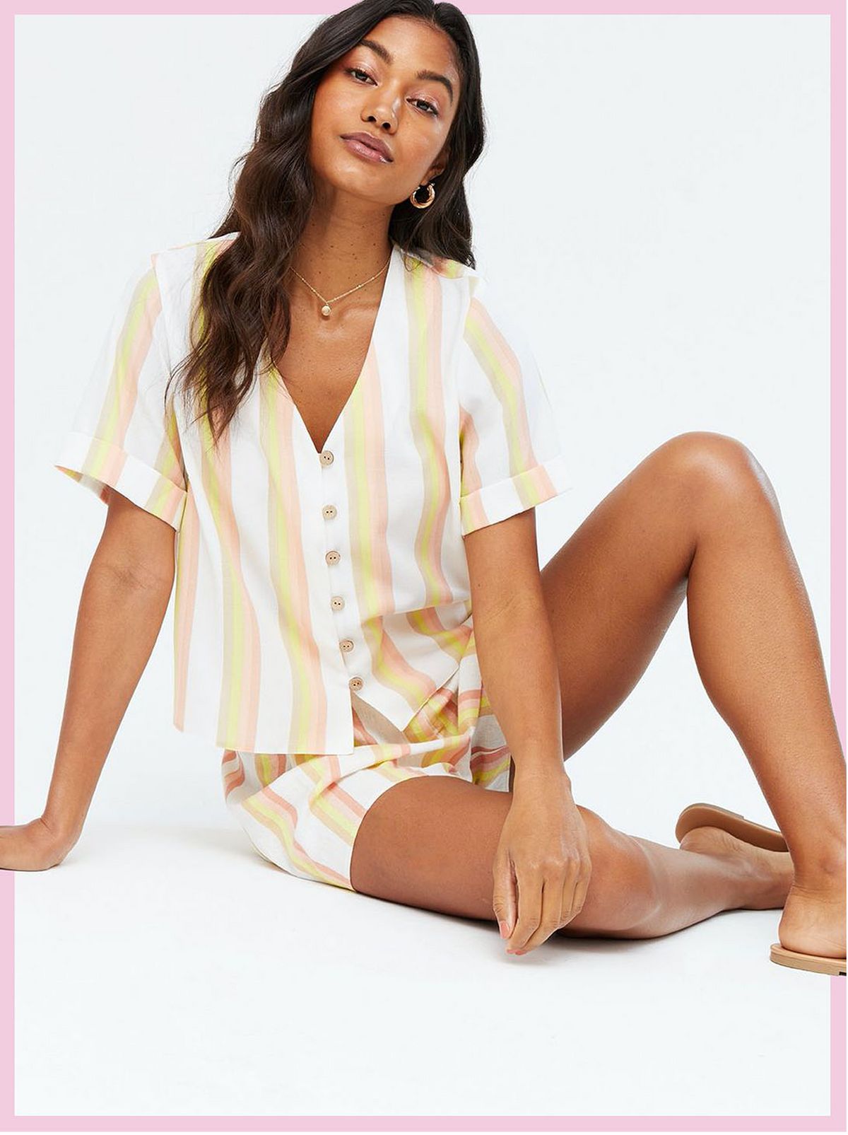 Woman wearing a white stripe button front shirt with matching shorts