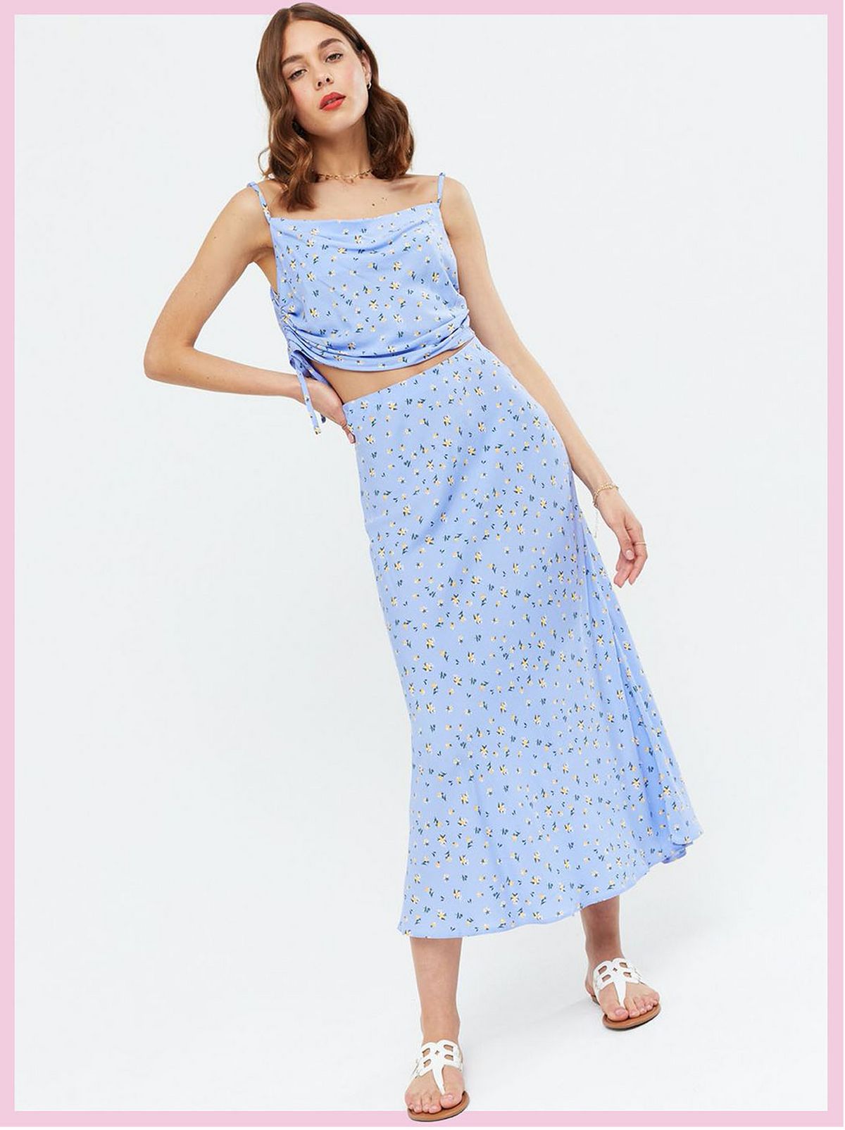 Woman wearing a blue ditsy floral ruched crop cami top and matching midi skirt with sandals