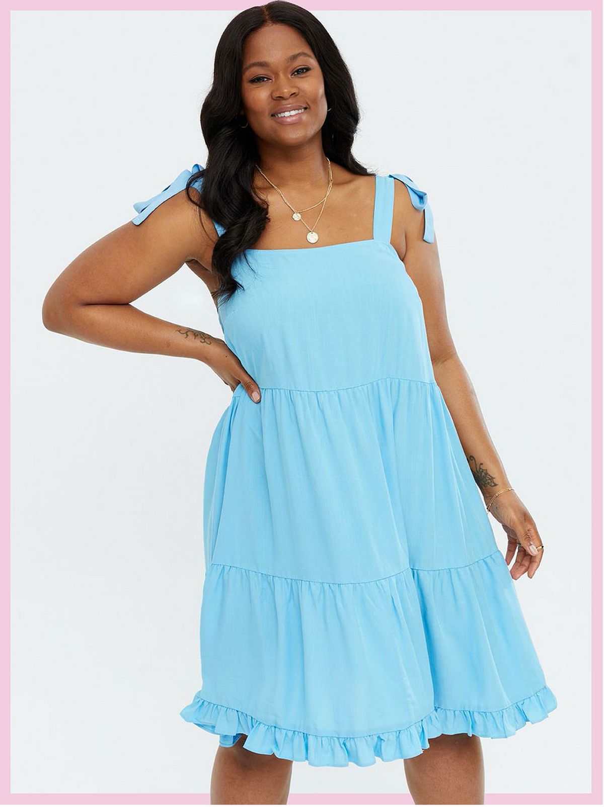 Woman wearing a blue tie strap square neck dress