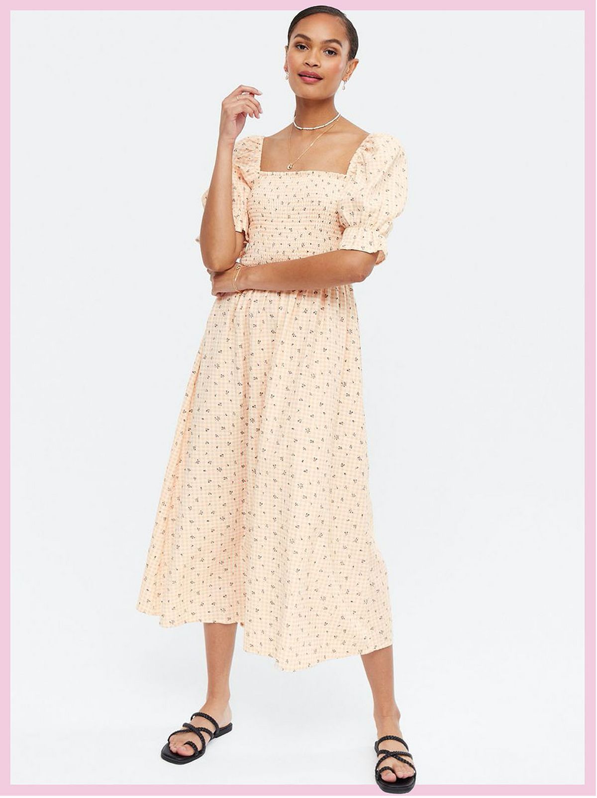 Woman wearing a pink gingham floral square neck midi dress and strappy sandals