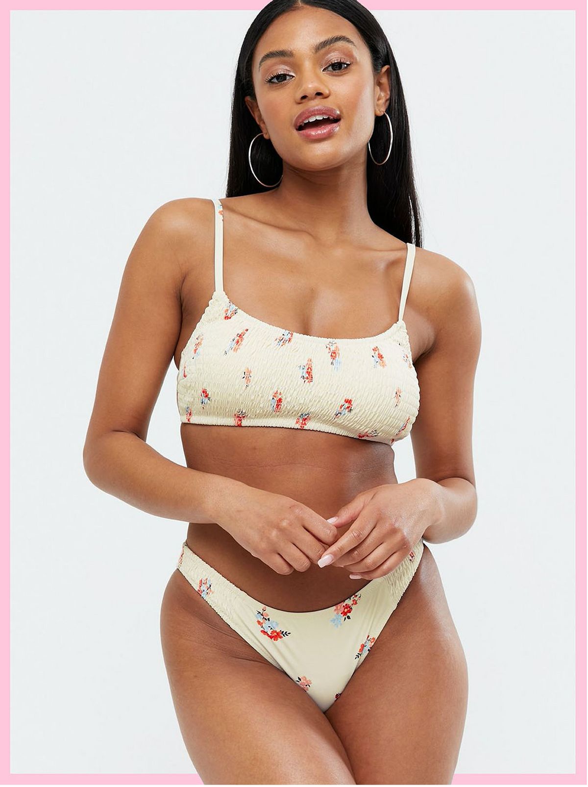 Woman wearing a white floral bikini top and matching bottoms
