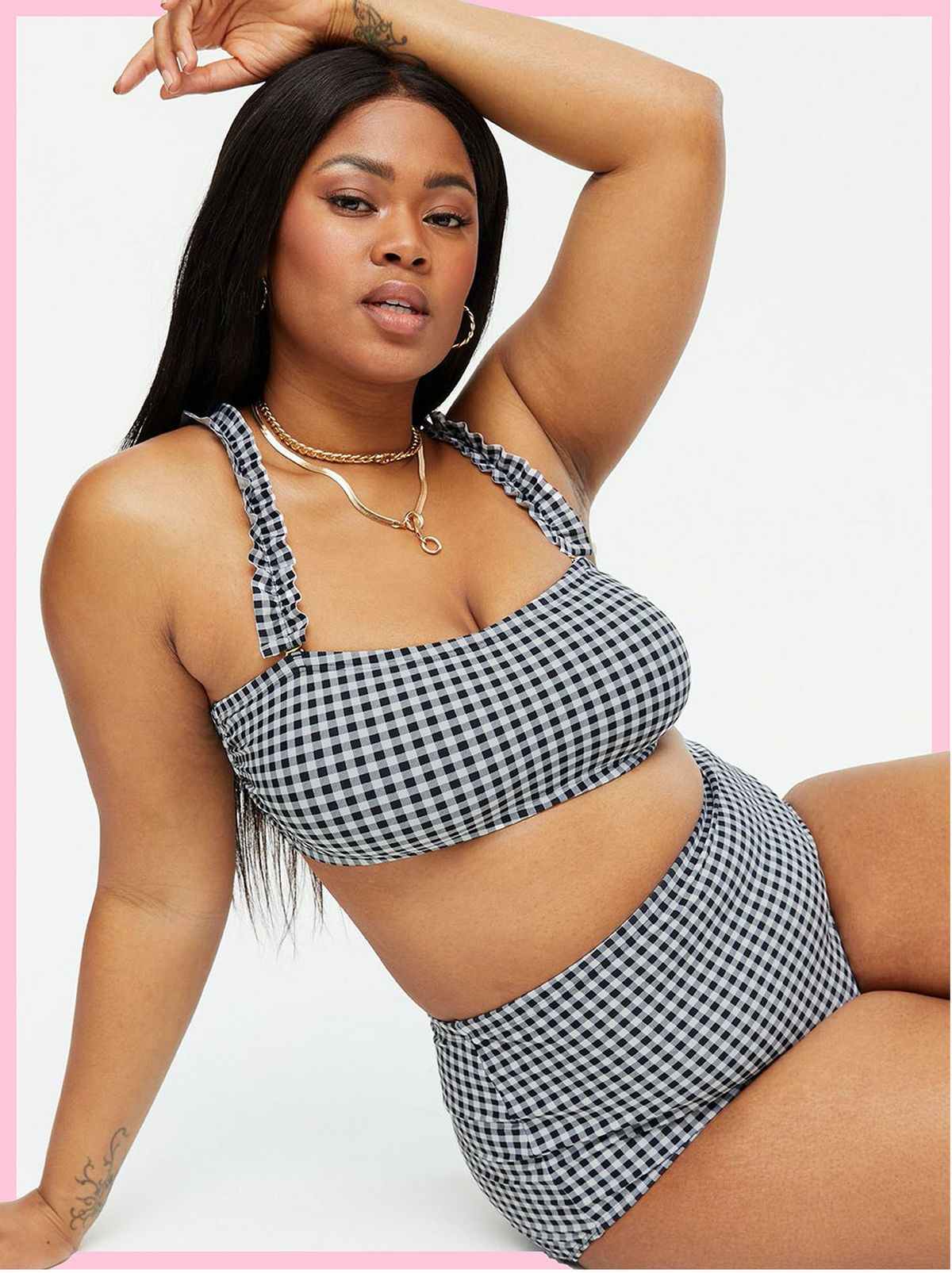 wearing a black gingham frill bandeau bikini and matching bottoms