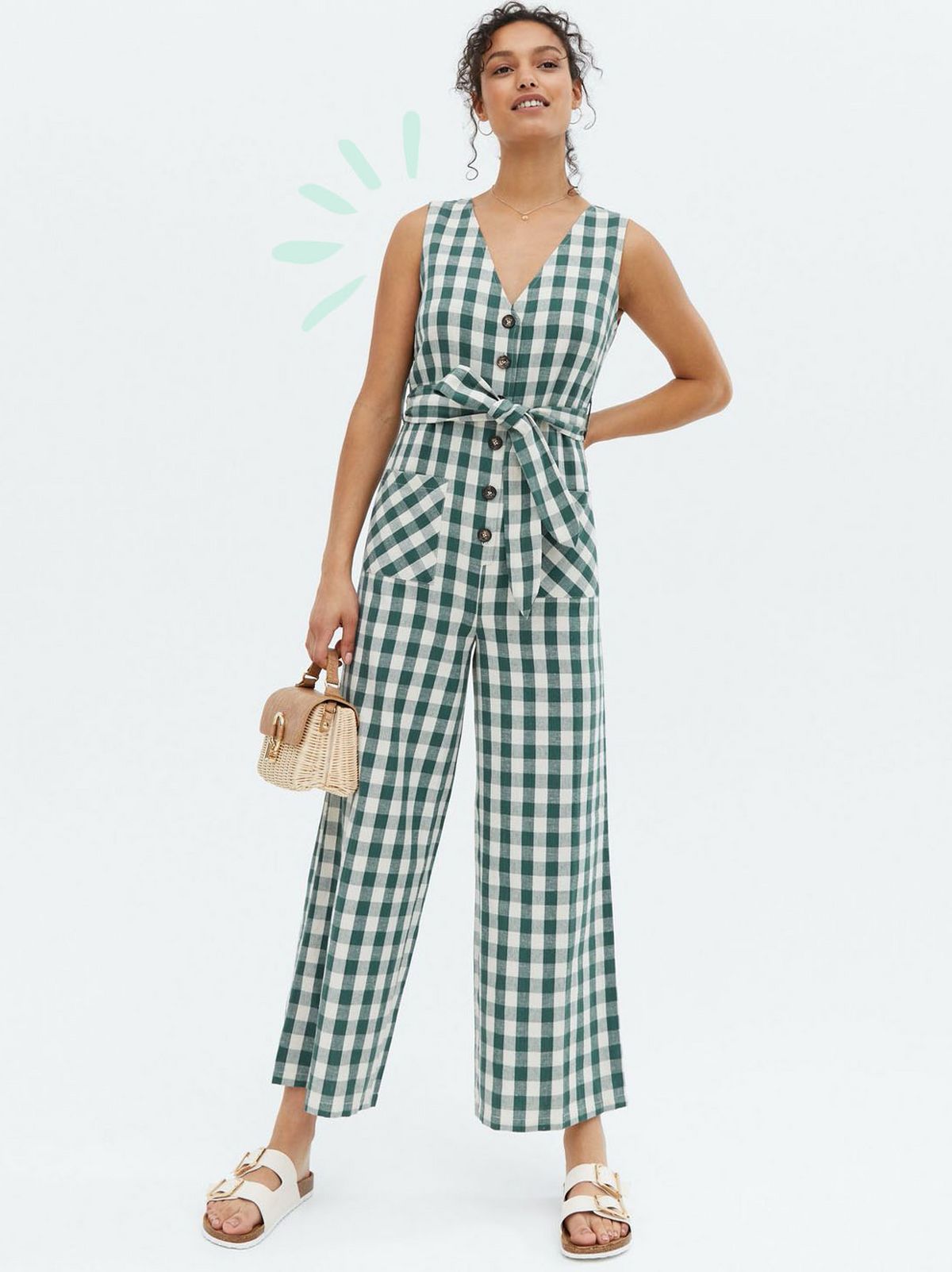 Woman wearing a green gingham check linen jumpsuit and chunky sandals