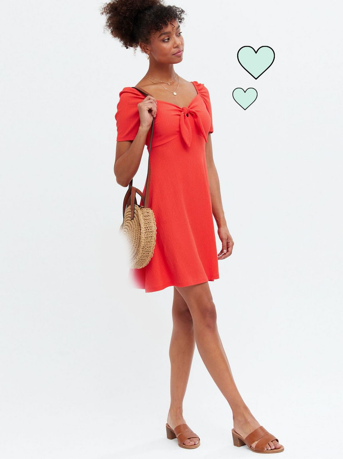 Woman wearing a red ribbed tie front mini dress and tan sandals