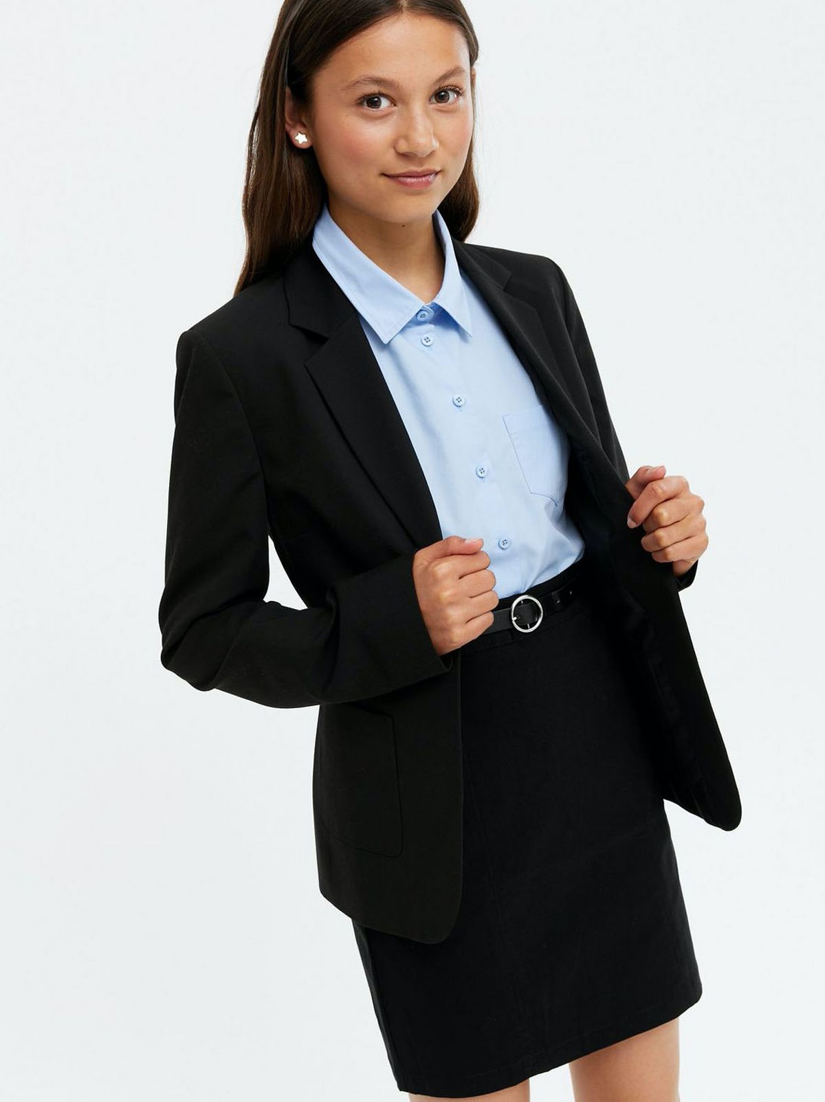Girl wearing a black single button school blazer, blue shirt and black skirt
