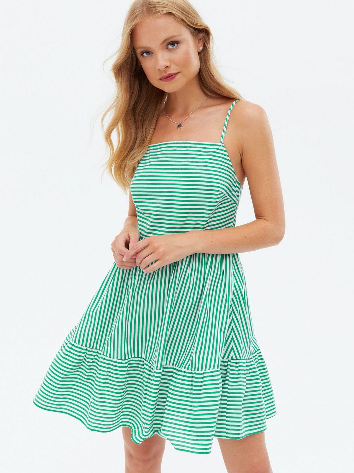 Woman wearing a green stripe poplin square neck sundress