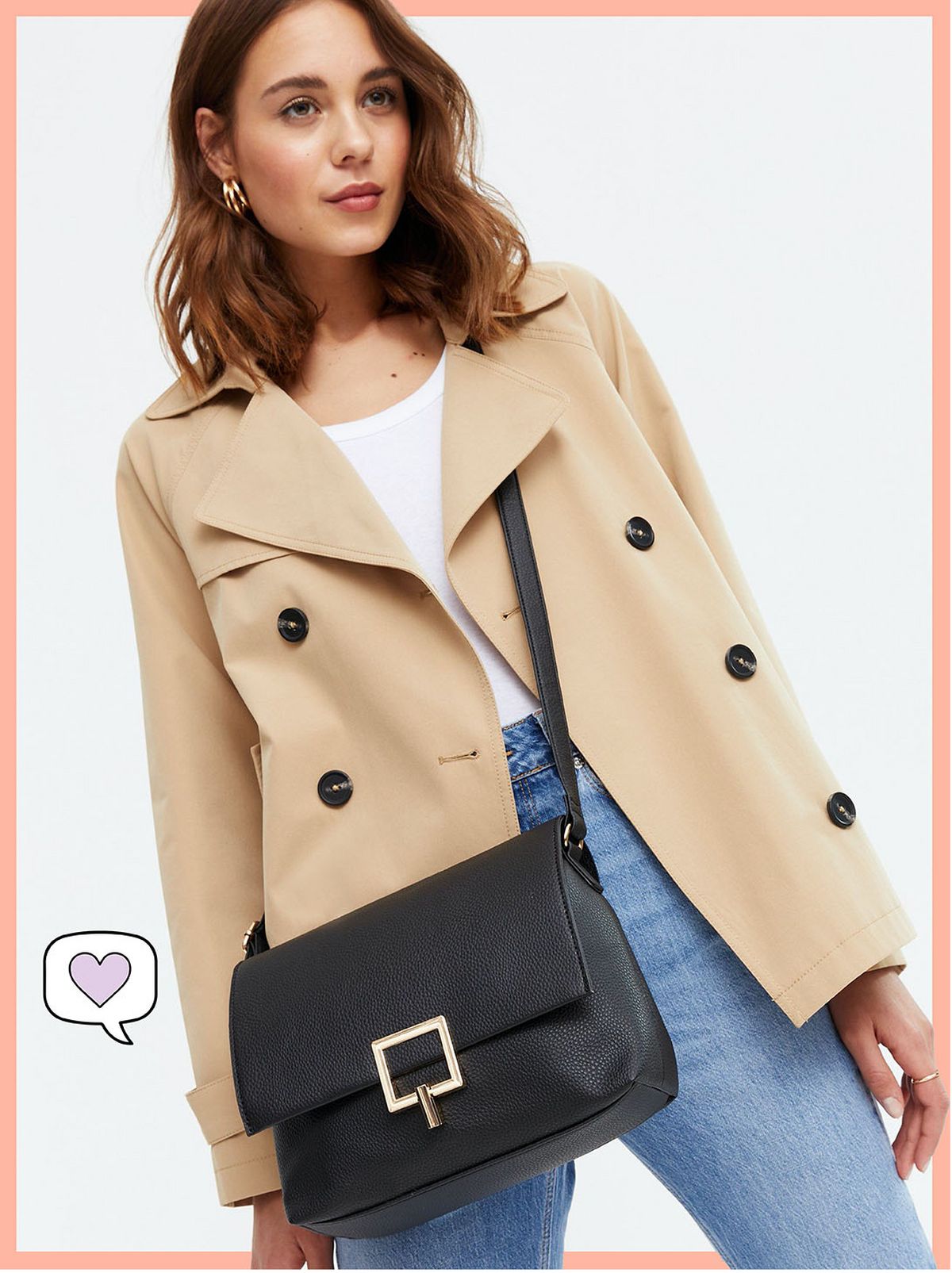Woman carrying a black leather look drawstring cross body bag, camel jacket, white top and blue jeans