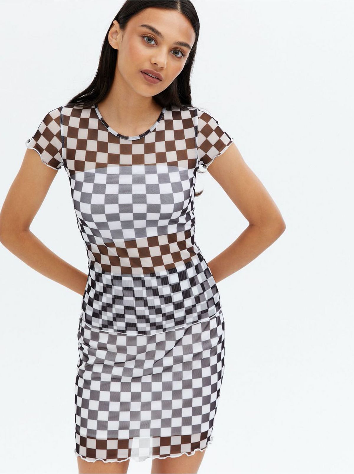 Woman wearing a white checkerboard mesh mini t-shirt