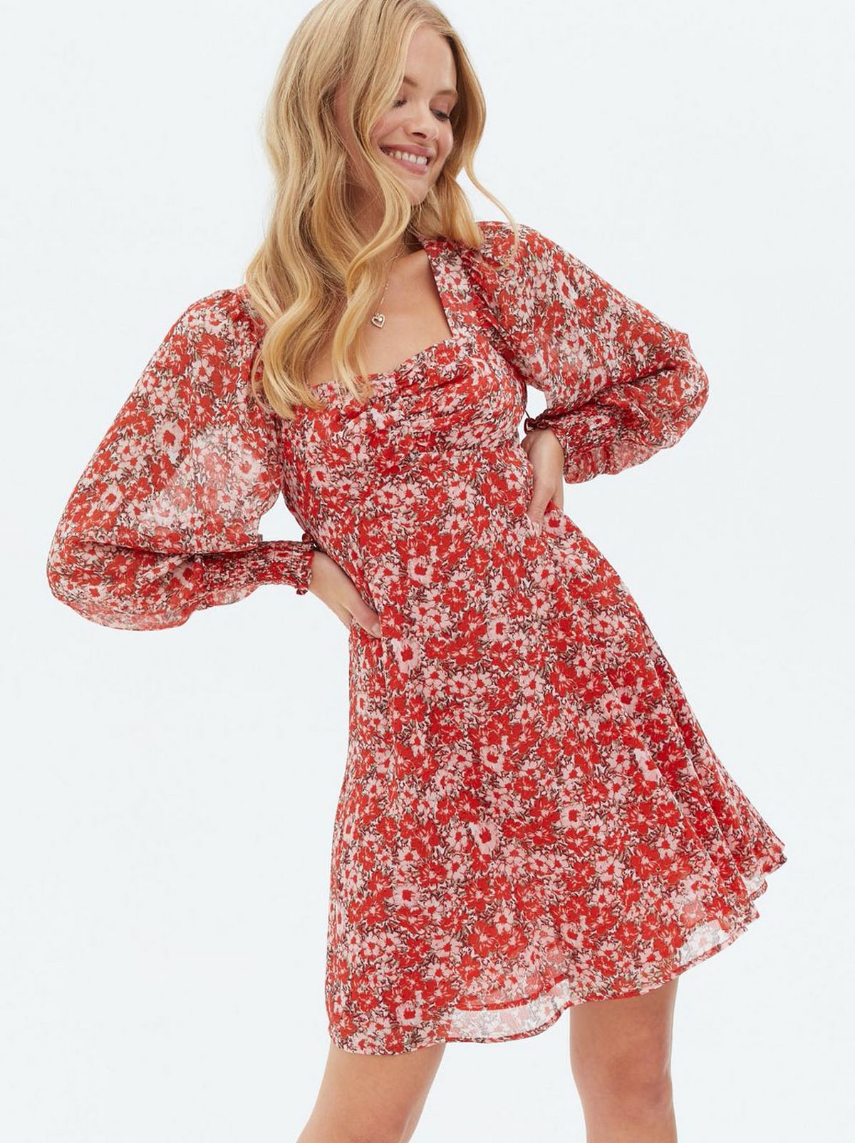 Woman wearing a red ditsy floral chiffon square neck mini dress
