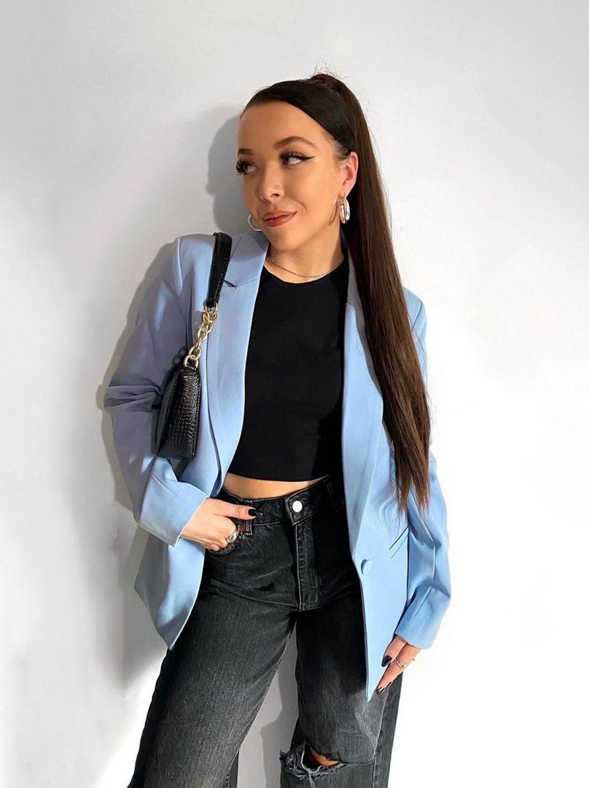 New Look's Ella Hacker wearing a blue blazer, black top and jeans