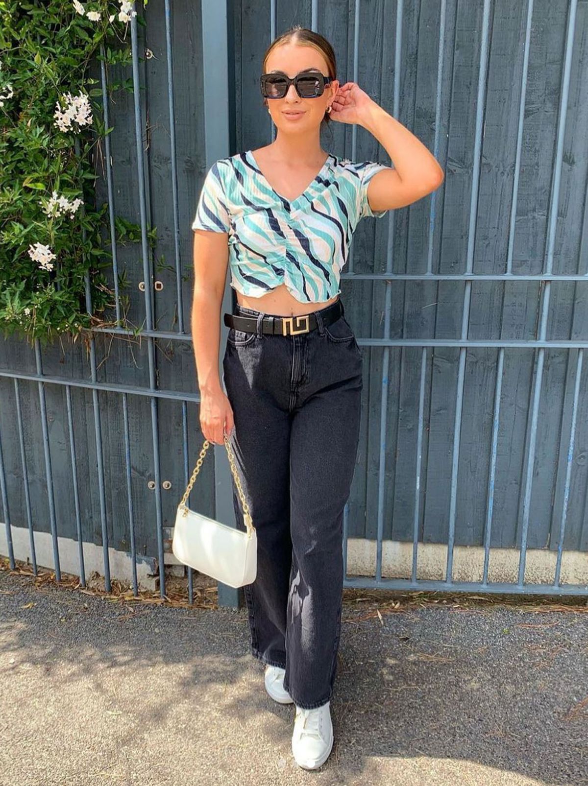 New Look's Georgia Lowrie wearing a blue and white blouse and black jeans