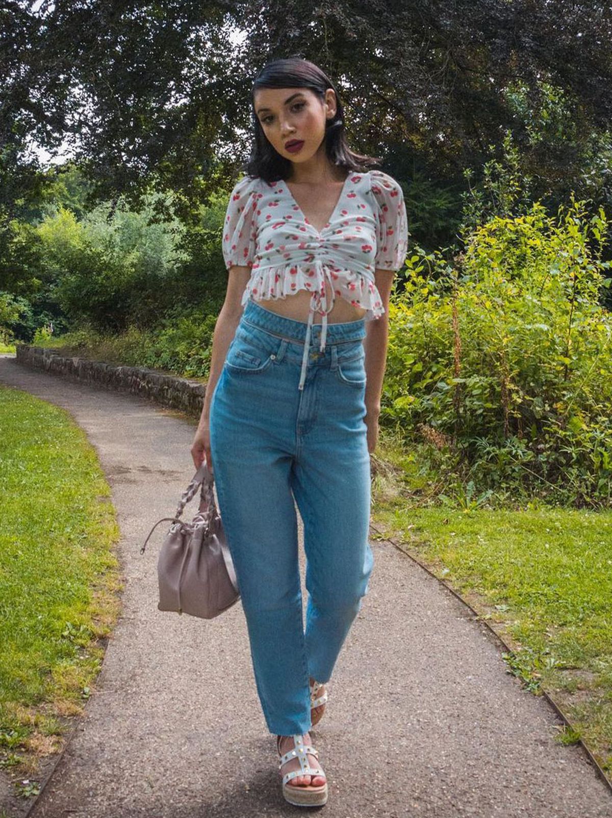 New Look's Luana Nuta wearing blue jeans and a white tie front top
