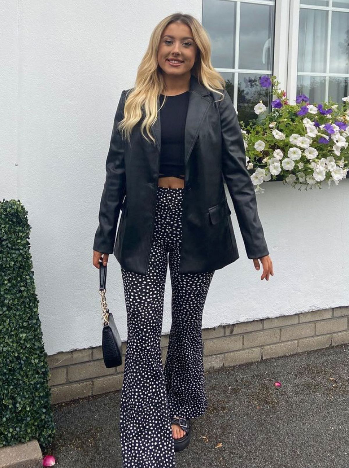 New Look's Lauren O'Gorman wearing spotted flared trousers, black top and leather jacket