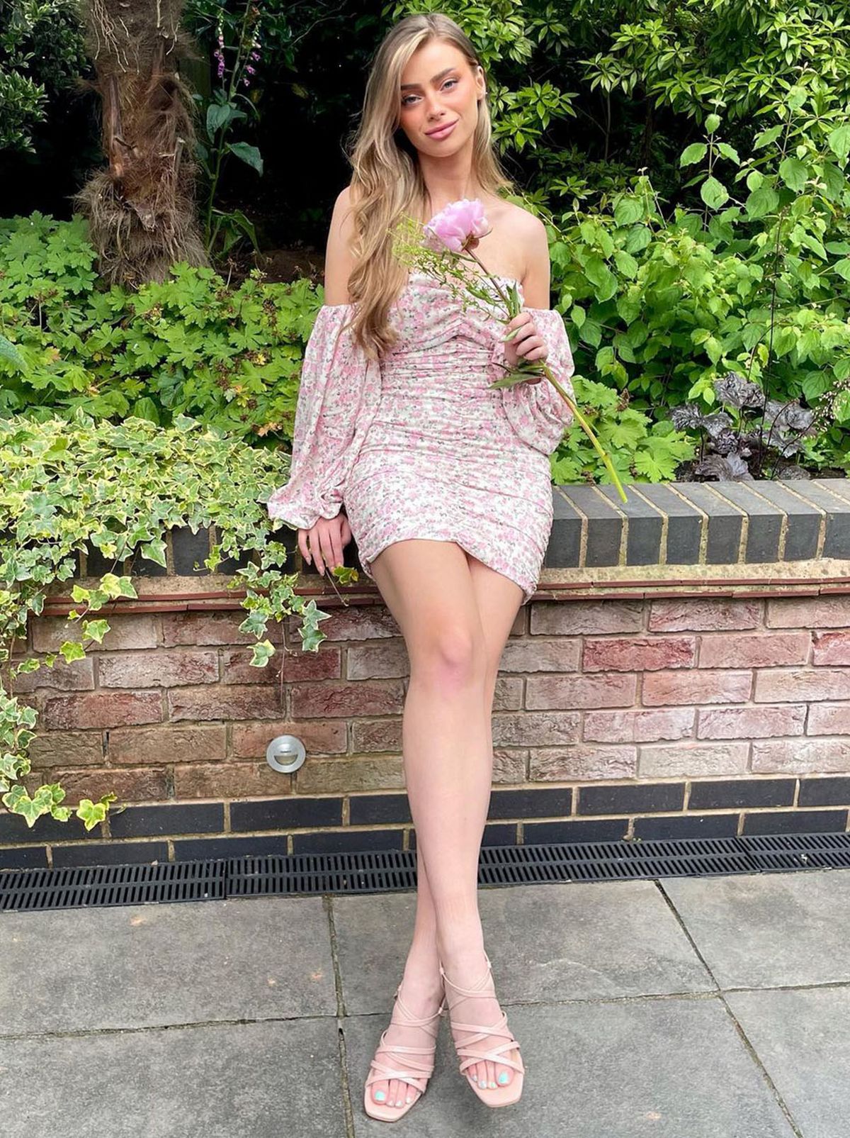 New Look's Emily Woodcock wearing a pink off the shoulder dress