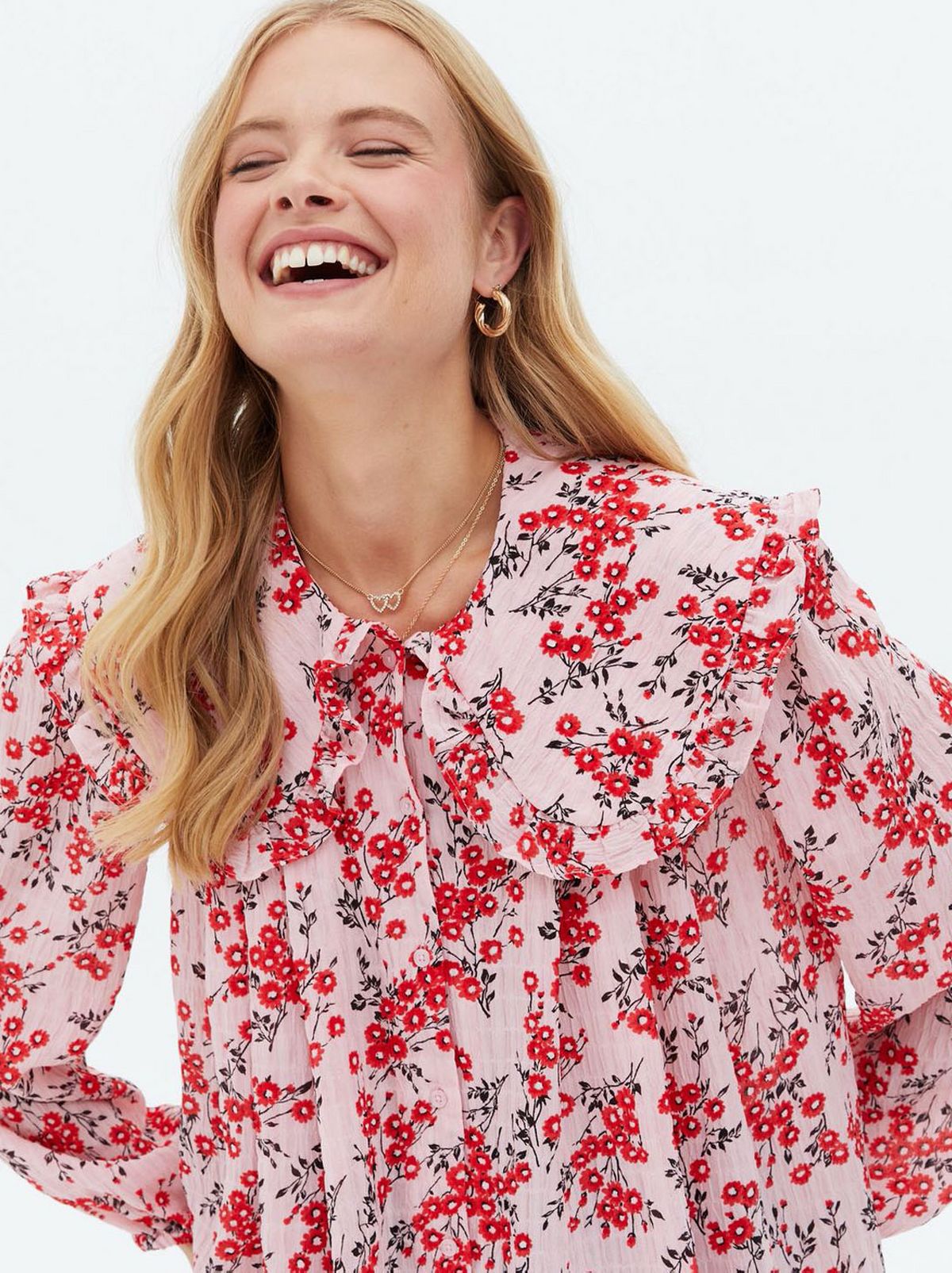 Woman wearing a pink floral frill collar blouse