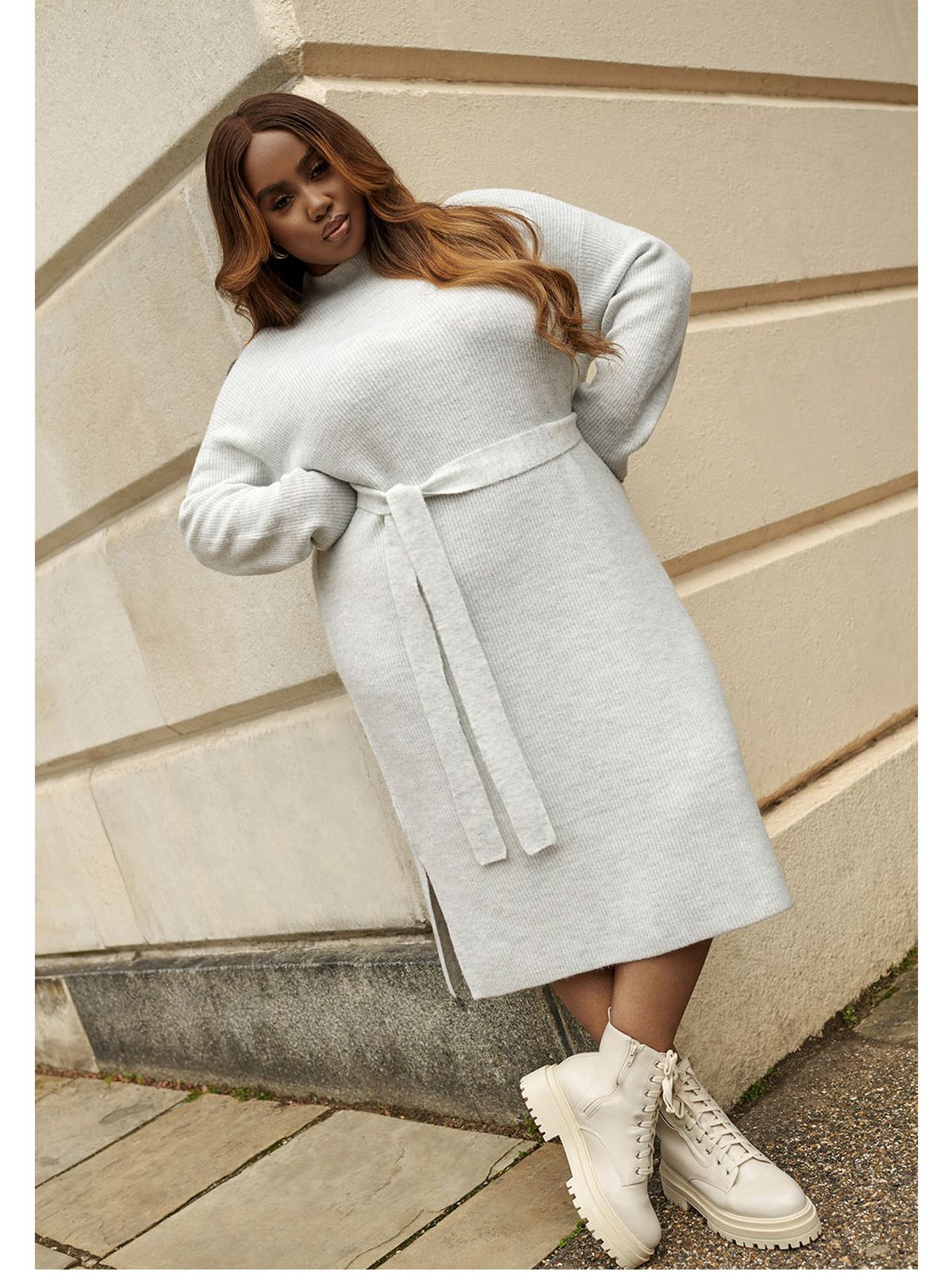 Lauren Nicole wearing a grey midi jumper dress and white chunky boots