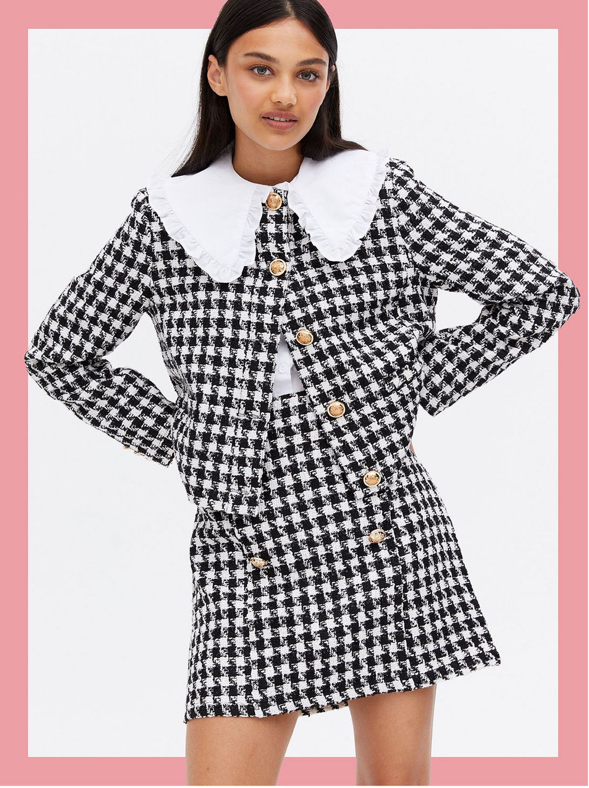 Woman wearing a black dogtooth button jacket and matching skirt