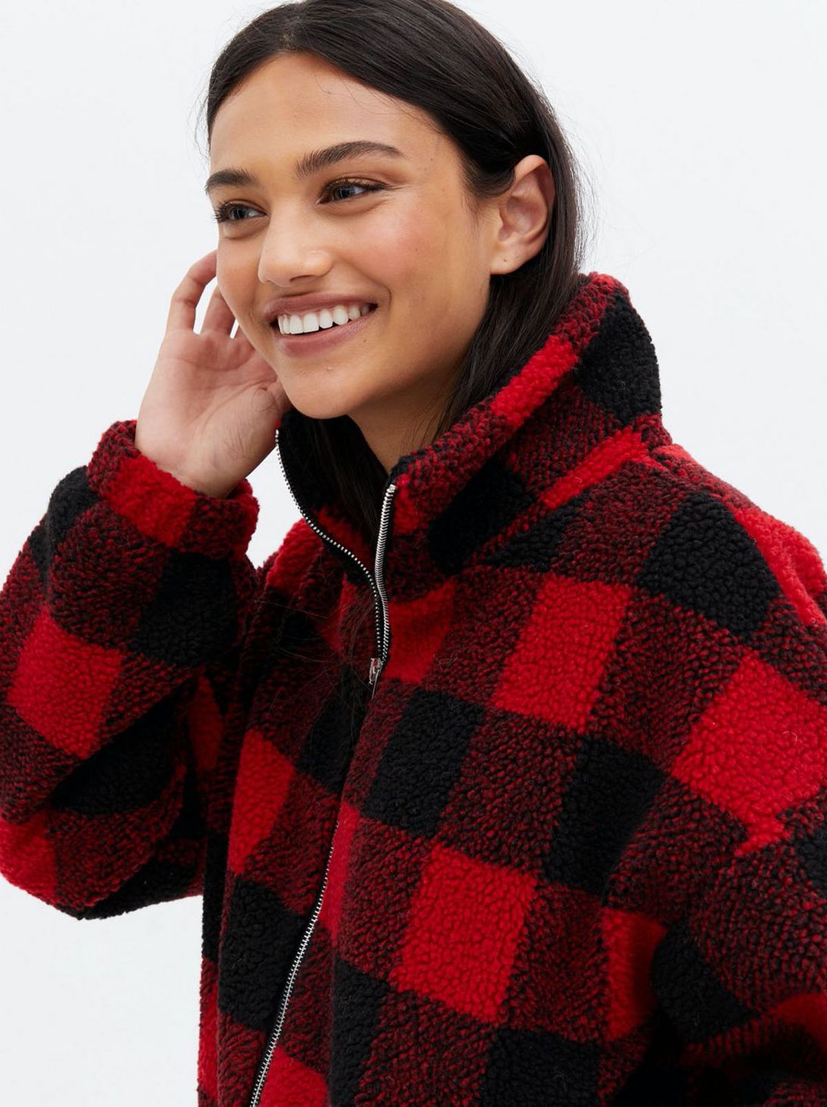 Woman wearing a red gingham teddy high neck jacket