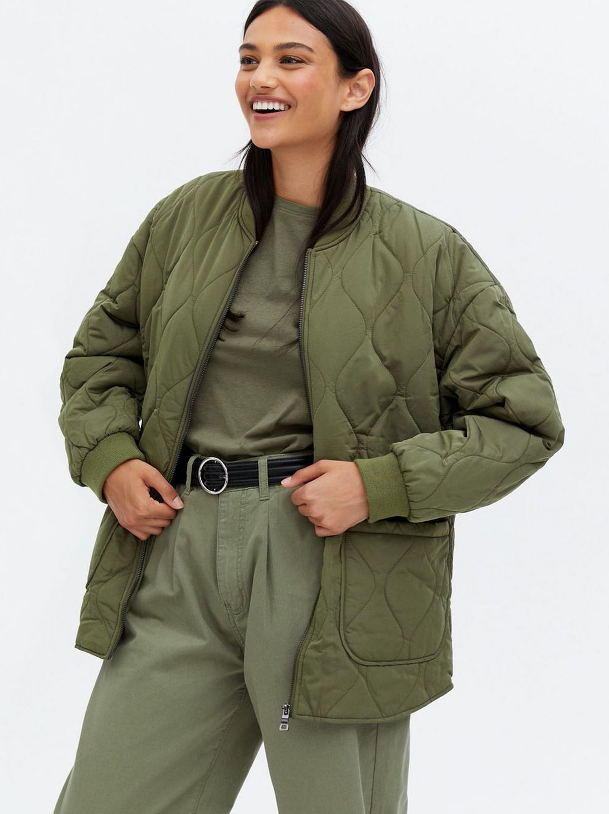 Woman wearing a khaki quilted zip jacket and khaki top and trousers